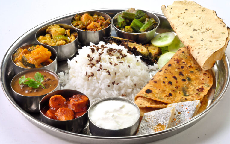 An Indian thali of basmati rice with dal, vegetable curries and roti