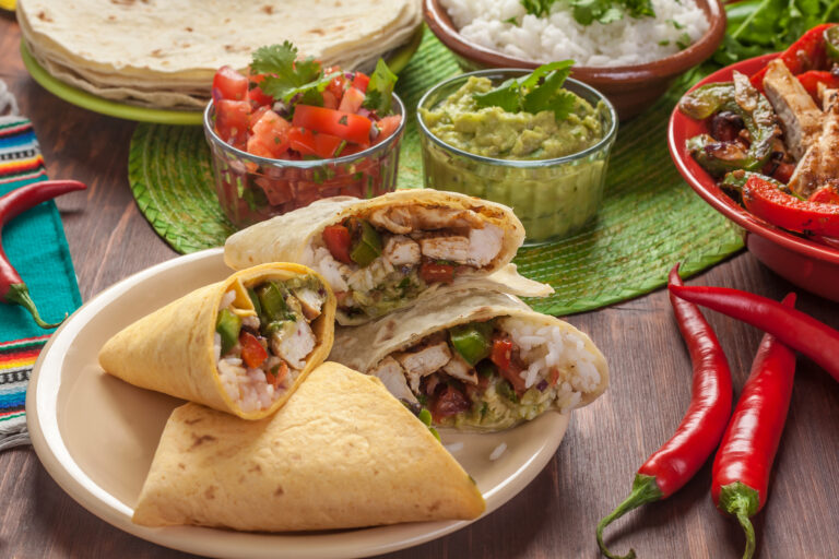 Chicken burritos filled with rice, pico de gallo and guacamole