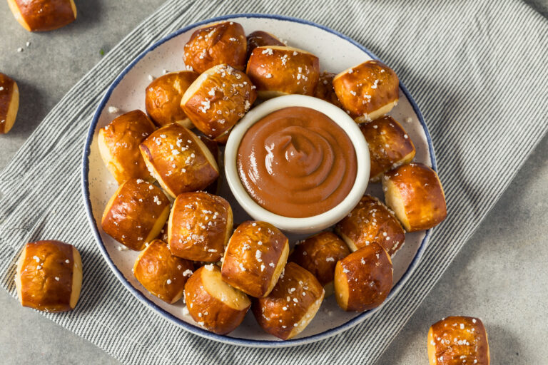 Warm pretzel bites served with a pot of honey mustard for dipping