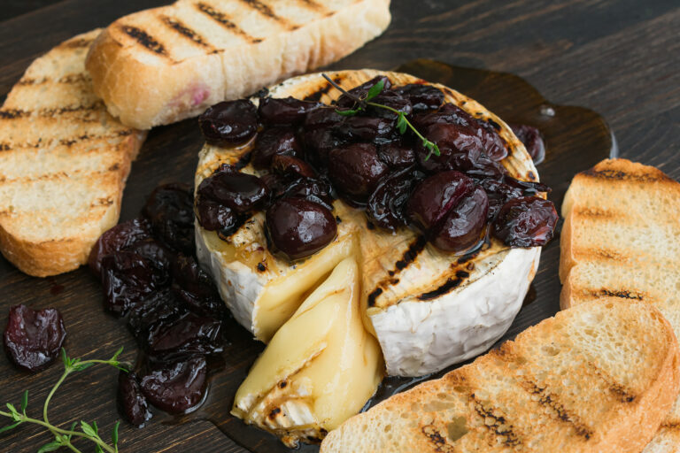Grilled brie topped with Amarena cherries and thyme honey, with grilled ciabatta
