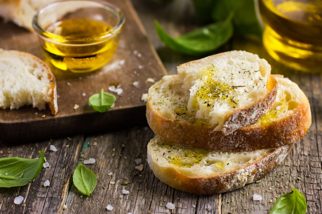 Extra virgin olive oil poured over toasted ciabatta
