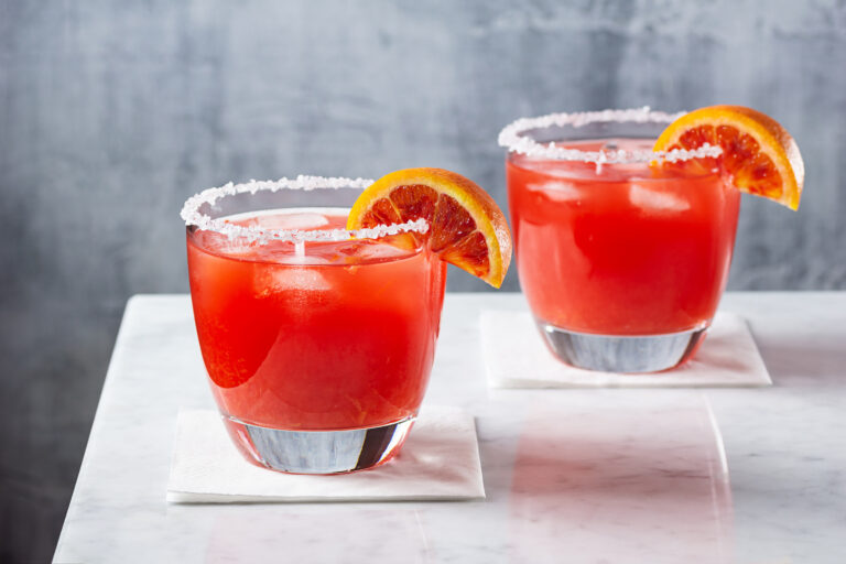 Two blood orange margaritas with salted rims